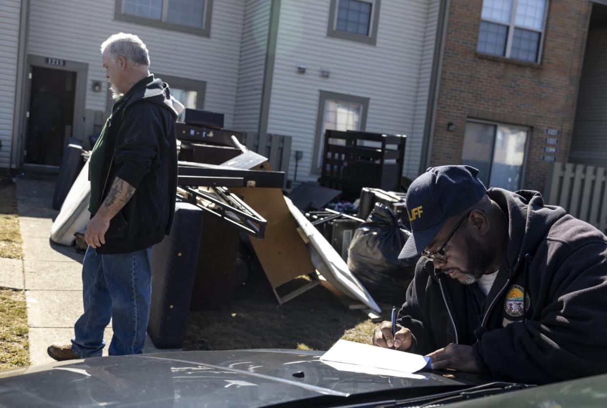 <span class="caption">Outside Columbus, Ohio, a bailiff signs a writ of eviction for a tenant on March 3, 2021.</span> <span class="attribution"><a class="link " href="https://www.gettyimages.com/detail/news-photo/deputy-service-bailiff-michael-taylor-signs-a-writ-of-news-photo/1231503422" rel="nofollow noopener" target="_blank" data-ylk="slk:Stephen Zenner/Getty Images;elm:context_link;itc:0;sec:content-canvas">Stephen Zenner/Getty Images</a></span>