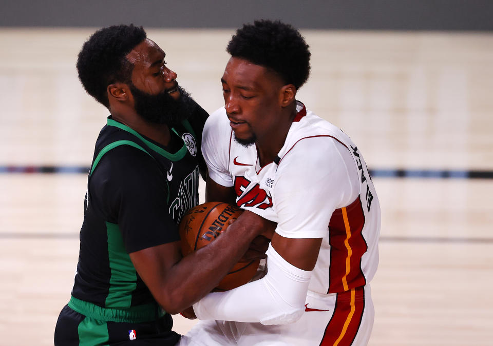 LAKE BUENA VISTA, FLORIDA - SEPTEMBER 25: Bam Adebayo #13 of the Miami Heat and Jaylen Brown #7 of the Boston Celtics fight for possession during the first quarter in Game Five of the Eastern Conference Finals during the 2020 NBA Playoffs at AdventHealth Arena at the ESPN Wide World Of Sports Complex on September 25, 2020 in Lake Buena Vista, Florida. NOTE TO USER: User expressly acknowledges and agrees that, by downloading and or using this photograph, User is consenting to the terms and conditions of the Getty Images License Agreement.  (Photo by Mike Ehrmann/Getty Images)