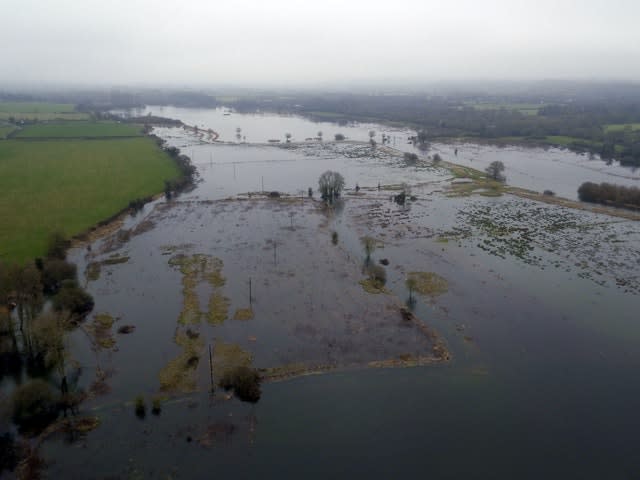 Temperature rises will increase heavy rainstorms which cause flooding (Steve Parsons/PA)