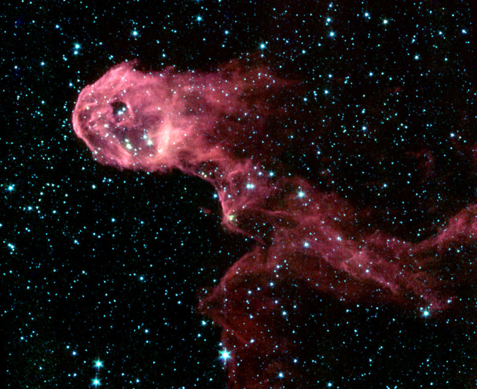 Image shows composite image of Elephant's Trunk Nebula, an elongated dark globule within the emission nebula IC 1396 in the constellation of Cepheus, one of the first images from the new Spitzer Space Telescope released by NASA on December 18, 2003. The new Spitzer Space Telescope, that looks at the cosmos with infrared detectors, has lifted the dust veils from newborn stars and a bumptious comet, and revealed the detail in the spiral arms of a neighboring galazy. Unlike the [Hubble Space Telescope], which takes pictures of the universe from high in Earth orbit, Spitzer makes its observations as it trails behind Earth as our planet circles the sun. Reuters