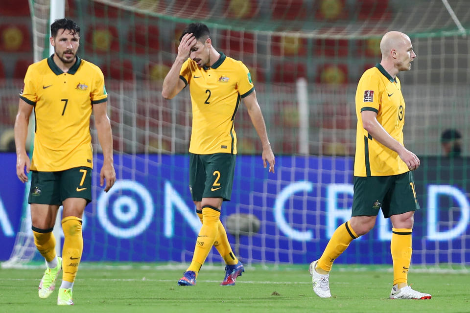 Mathew Leckie, Milos Degenek and Aaron Mooy look dejected after conceding their second goal during the FIFA World Cup Qatar 2022 Qualifier match against Oman.