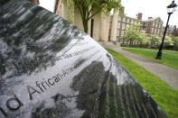 Words engraved on a stone plinth form a component of the Slavery Memorial by sculptor Martin Puryear, erected in 2014, on the Brown University campus in Providence, R.I., on Tuesday, May 4, 2021. An “Anti-Black Racism” task force is expected to deliver recommendations soon for how the school can further promote racial equity. But university spokesperson Brian Clark stressed it’s not clear whether the panel, which was formed during last summer’s racial unrest, will address reparations. (AP Photo/Steven Senne)