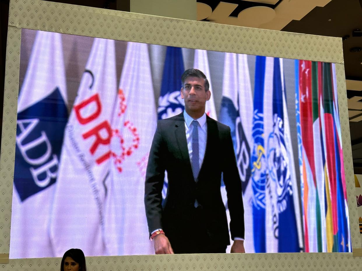 Rishi Sunak’s arrival at the summit is seen from one of the giant screens at the venue’s vast media centre (Shweta Sharma)