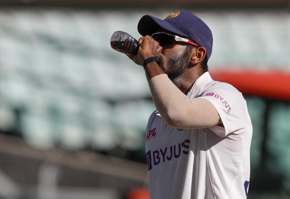 India's Jasprit Bumrah takes a drink during play on day three of the third cricket test between India and Australia at the Sydney Cricket Ground, Sydney, Australia, Saturday, Jan. 9, 2021. (AP Photo/Rick Rycroft)