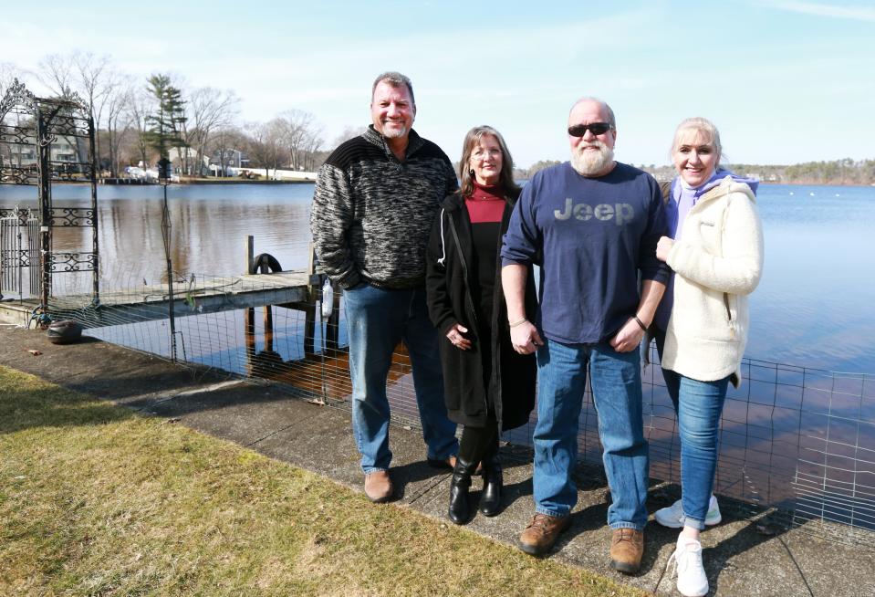 From left, Taunton City Councilor John McCaul and waterfront residents on Lake Sabbatia Lisa Potte, Craig DeMoura and Pegi Conte at Lake Sabbatia on Friday, March 11, 2022.