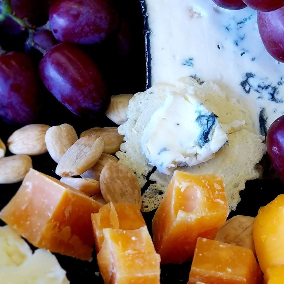 A selection of cheeses, crackers, fruit, nuts, meats and a matched wine is a beautiful and elegant way to feed guests at a holiday cocktail party.