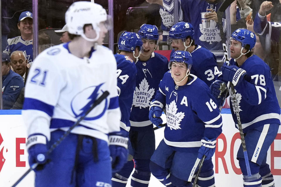 Toronto Maple Leafs right wing Mitchell Marner (16) celebrates with teammates after scoring against the Tampa Bay Lightning during third-period NHL hockey game action in Toronto, Monday, Nov. 6, 2023. (Chris Young/The Canadian Press via AP)