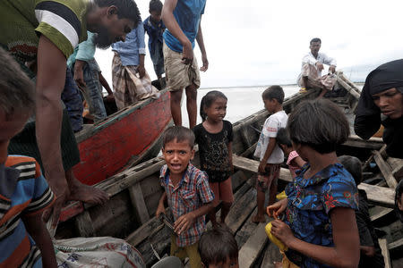 Rohingya refugees wait to be transported to Cox's Bazar after their arrival, Bangladesh September 18, 2017. REUTERS/Cathal McNaughton