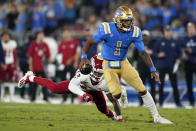 UCLA quarterback Dorian Thompson-Robinson (1) runs past Fresno State defensive back Justin Houston (13) during the first half of an NCAA college football game Saturday, Sept. 18, 2021, in Pasadena, Calif. (AP Photo/Marcio Jose Sanchez)