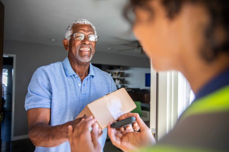 Man accepting package from a delivery driver