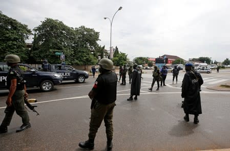 Members of the police are seen at Banex road junction after dispersing members of the IMN from a street in Abuja
