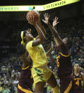 Oregon's Ruthy Hebard, center, shoots between Arizona State's Sophia Elenga, left, and Charnea Johnson-Chapman during the first quarter of an NCAA college basketball game Friday, Jan 18, 2019, in Eugene, Ore. (AP Photo/Chris Pietsch)