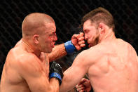 <p>Georges St-Pierre of Canada lands a punch to take down Michael Bisping of England in their UFC middleweight championship bout during the UFC 217 event at Madison Square Garden on November 4, 2017 in New York City. (Photo by Josh Hedges/Zuffa LLC/Zuffa LLC via Getty Images) </p>