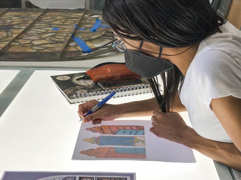 Memphis artist Sharday Michelle fines tunes her design for the west elevation windows of historic Clayborn Temple during a 2021 artist intensive at Pearl River Glass Studio in Jackson. During the intensive, she and fellow Memphis artist Lonnie Robinson learned how to interpret their work in glass. Michelle and Robinson have designed and are currently working on replacement windows destroyed by police teargas canisters during the 1968 "I AM A MAN" demonstrations.