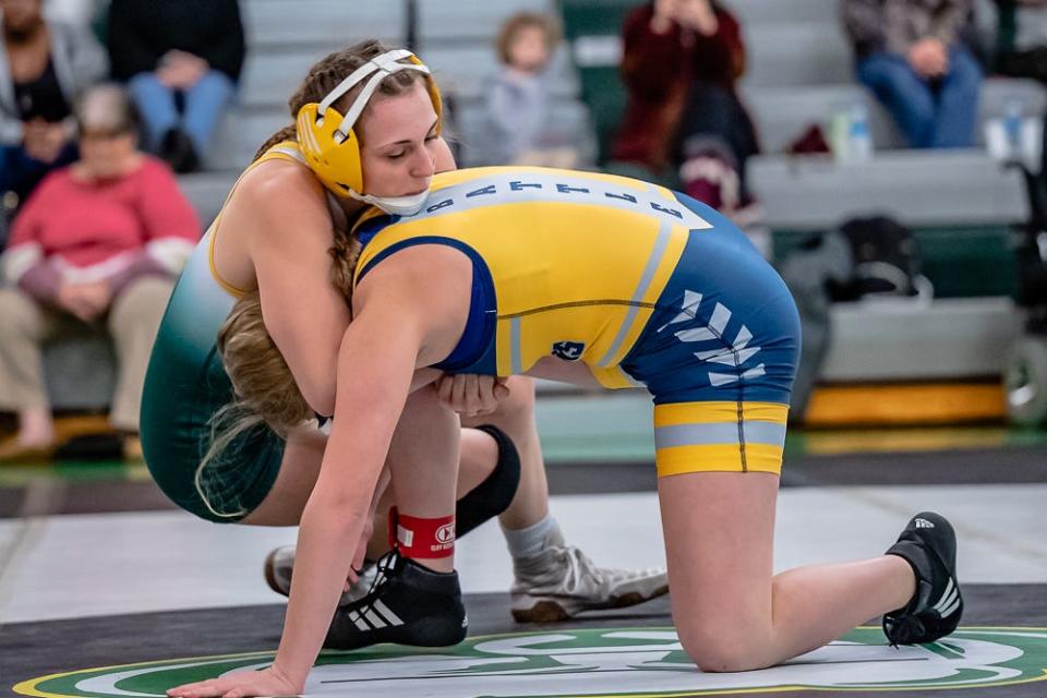 Rock Bridge's Anna Stephens, left, starts to roll Battle's Aubrey Porter into a cradle during a match Jan. 4.