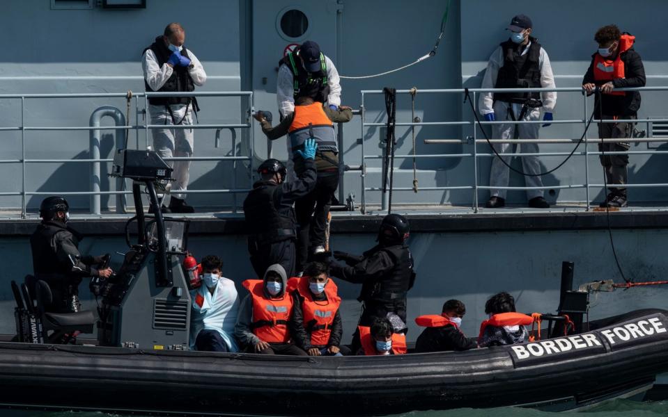 Border Force officials move newly arrived Channel migrants between vessels outside Dover Harbour in Kent - Dan Kitwood/Getty Images