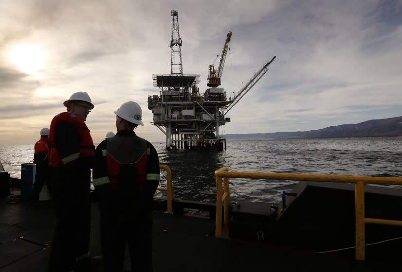 GOLETA, CA ? MARCH 07, 2018: Chris Peltonen, left, president, Beacon West, watches as the boat pulls away from oil platform Holly in the Pacific Coast waters near Santa Barbara at sunset on March 07, 2018. (Al Seib / Los Angeles Times)