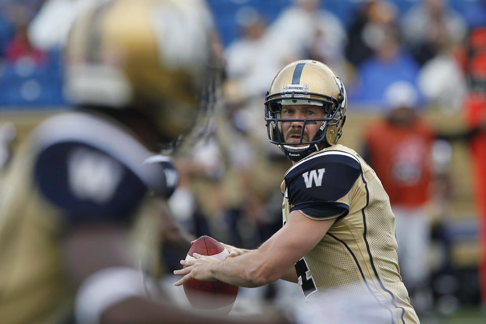 Winnipeg Blue Bombers' Buck Pierce (4) gets set to throw against the Hamilton Tiger-Cats during the first half of their pre-season CFL game in Winnipeg Wednesday, June 20, 2012. THE CANADIAN PRESS/John Woods