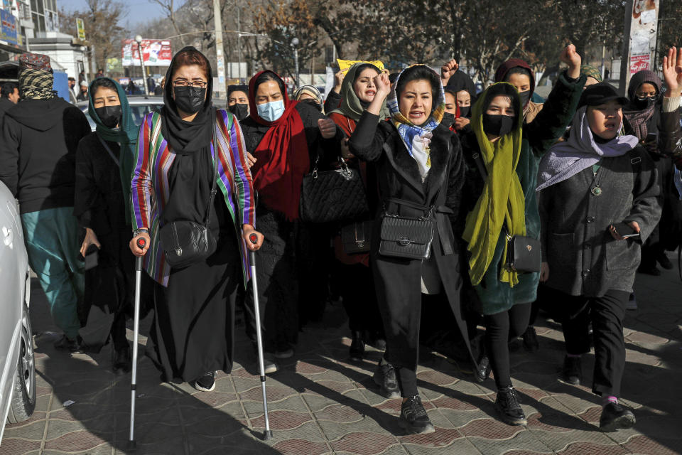 FILE - Afghan women chant slogans during a protest against the ban on university education for women, in Kabul, Afghanistan, Thursday, Dec. 22, 2022. The U.S. has condemned the Taliban for ordering non-governmental groups in Afghanistan to stop employing women, saying the ban will disrupt vital and life-saving assistance to millions. It is the latest blow to female rights and freedoms since the Taliban seized power last year and follows sweeping restrictions on education, employment, clothing and travel.(AP Photo, File)