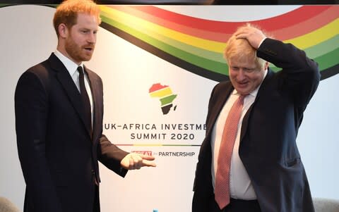 Prince Harry, Duke of Sussex, speaks with British Prime Minister Boris Johnson as they attend the UK-Africa Investment Summit - Credit: Getty