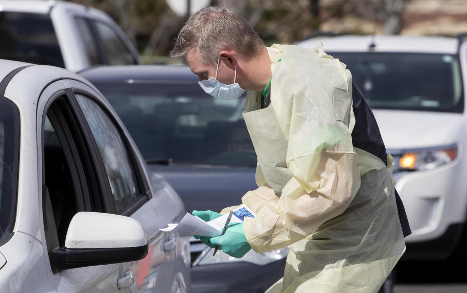 Nurse manager Cullen Anderson, RN, screens people in a line of cars waiting to be tested for coronavirus COVID-19 at a drive-thru testing station at St. Luke's Meridian Medical Center Tuesday, March 17, 2020. (Darin Oswald/Idaho Statesman/Tribune News Service via Getty Images)