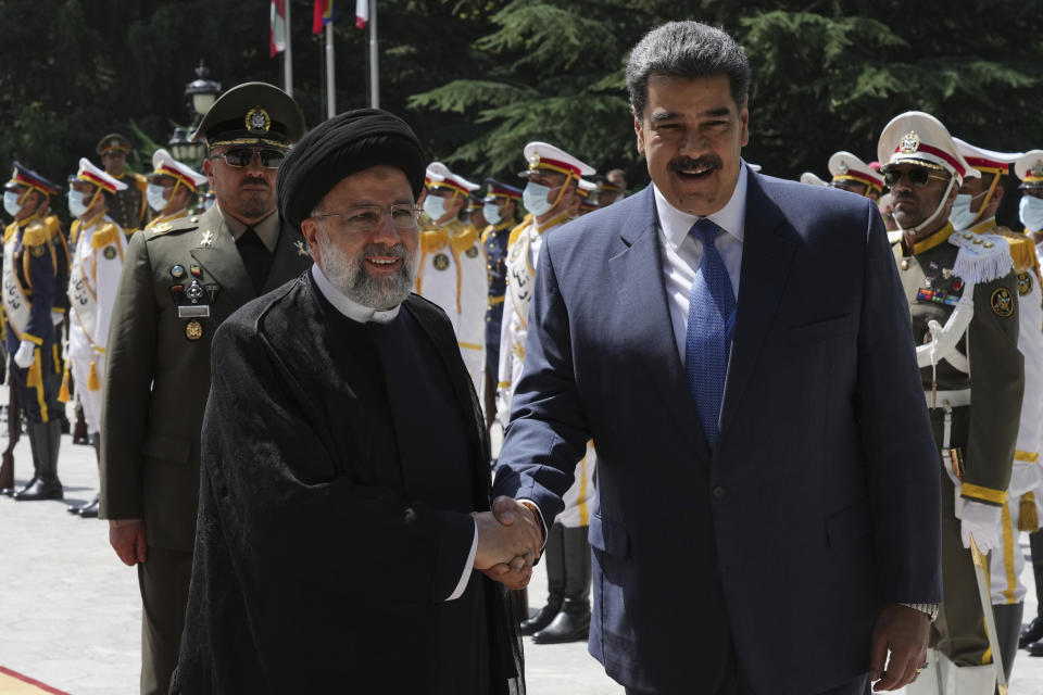 Venezuela's President Nicolas Maduro, right, is welcomed by his Iranian counterpart Ebrahim Raisi during his official welcoming ceremony at the Saadabad Palace in Tehran, Iran, Saturday, June 11, 2022. (AP Photo/Vahid Salemi)