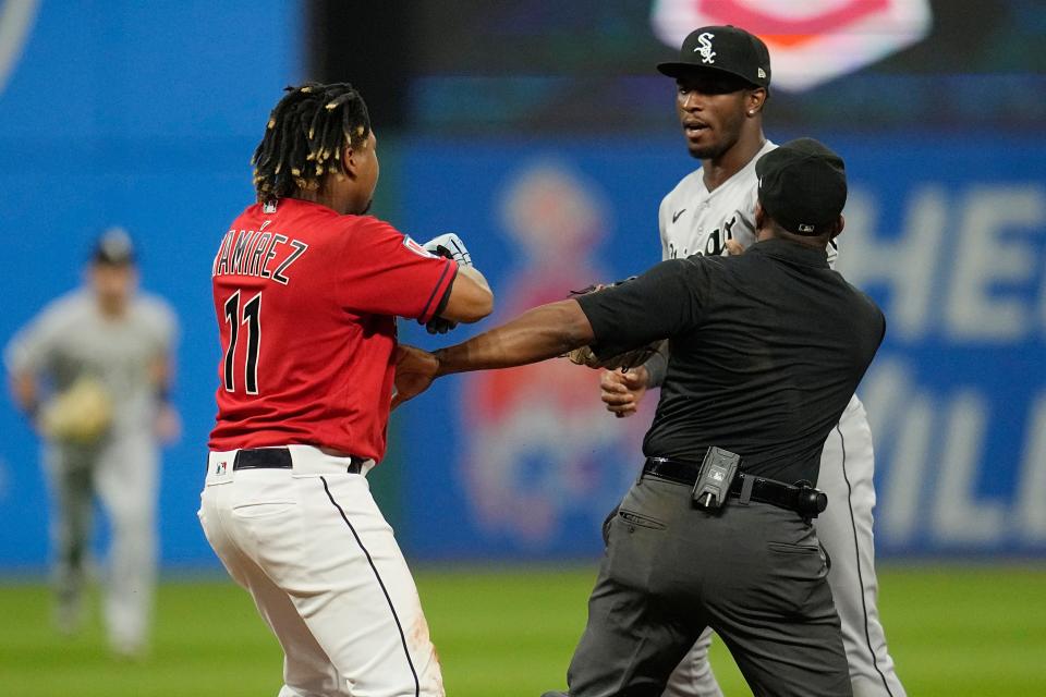 Second base umpire Malachi Moore, front right, gets between Cleveland Guardians' Jose Ramirez (11) and Chicago White Sox's Tim Anderson, back right , in the sixth inning Saturday in Cleveland.