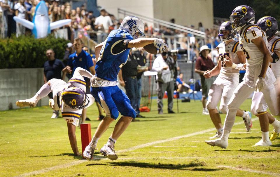 Ripon Christian’s Trevor Van Elderen scores a touchdown past Orestimba’s Colby Cabral during the Southern League game in Ripon, Calif., Friday, Sept. 22, 2023.