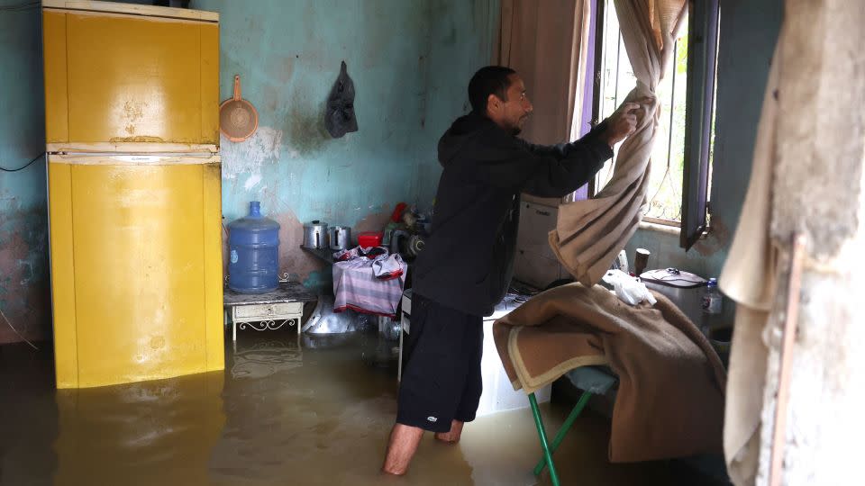 Construction worker Nicelio Goncalves, 52, shows the interior of his flooded house outside in Rio de Janeiro state on Sunday, March 24. - Pilar Olivares/Reuters