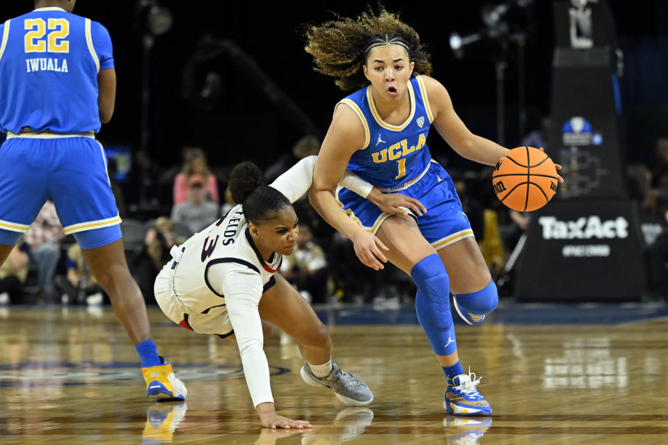 UCLA guard Kiki Rice (1) drives against Arizona guard Lauren Fields during the first half of an NCAA college basketball game in the quarterfinal round of the Pac-12 women's tournament Thursday, March 2, 2023, in Las Vegas. (AP Photo/David Becker)