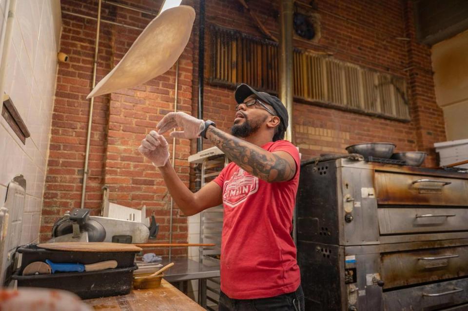 “We wanted to become that local pizza hub for the community where you can watch the game and grab a beer,” says Alan Kneeland, owner of The Combine, seen here making one of his restaurant’s signature pizzas.