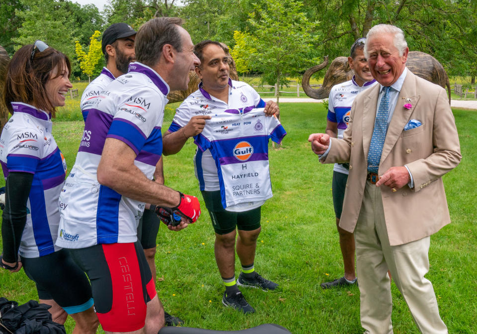 Rohit Chaddapresents the Prince of Wales with a cycling vest, which was two sizes too small, before he joined representatives of the British Asian Trust at Highgrove in Gloucestershire before they embark on the charity's 'Palaces on Wheels' cycling event. Picture date: Thursday June 10, 2021.