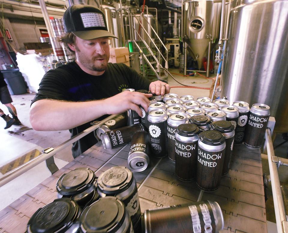 Charlie McDonough packages cans of 'Shadow Banned' after labels were affixed at Lavery Brewing Co. Lavery will sell canned beer Friday in the "Bunker" during Zoolarious with the Erie Zoo: A Comedy Benefit Show.