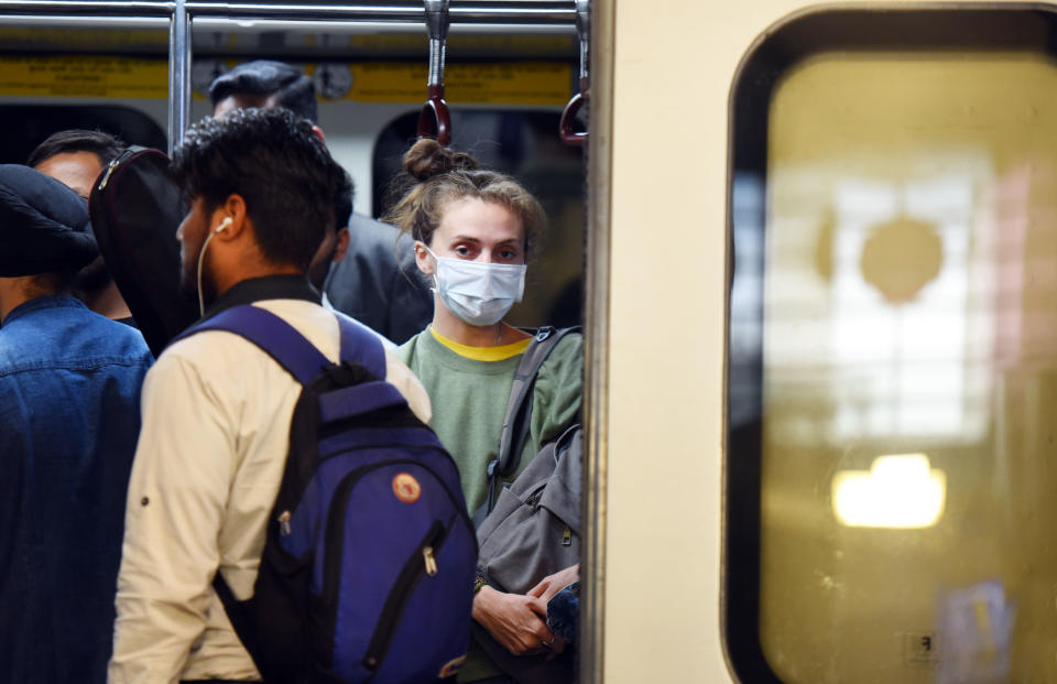 NEW DELHI, INDIA - MARCH 13: Commuters are seen at Rajiv Chowk Metro Station, some wearing protective masks as a precautionary measure amid rising coronavirus scare, on March 13, 2020 in New Delhi, India. The Delhi government on Thursday declared coronavirus an epidemic and shut all cinema halls, schools and colleges, except those where exams are on, till March 31. (Photo by Raj K Raj/Hindustan Times via Getty Images)
