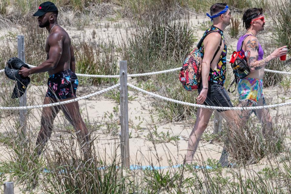 Visitors and residents enter and exit the Rehoboth Beach, on Saturday, May 27, 2023.