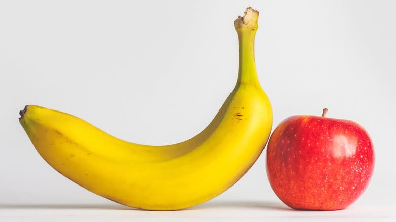 An apple and a banana on a white background