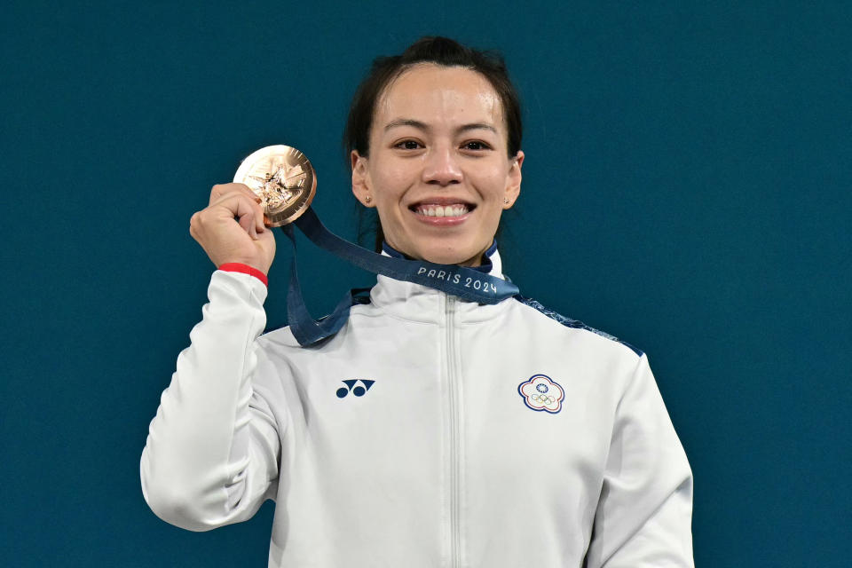 Bronze medallist Taiwan's Kuo Hsing-chun poses on the podium after the women's -59kg weightlifting event during the Paris 2024 Olympic Games at the South Paris Arena in Paris, on August 8, 2024. (Photo by Miguel MEDINA / AFP) (Photo by MIGUEL MEDINA/AFP via Getty Images)