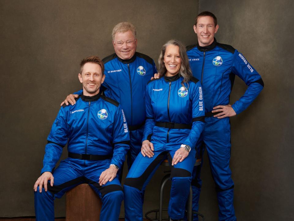 Chris Boshuizen, William Shatner, Audrey Powers, and Glen de Vries in blue space jumpsuits
