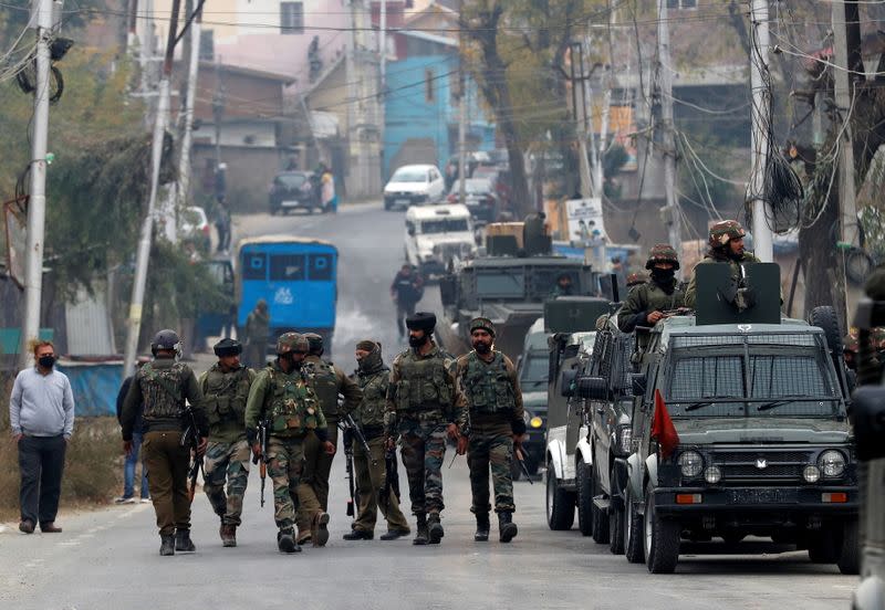 Indian soldiers leave a gun battle site after a suspected militant commander was killed in a gun battle between Indian security forces and suspected militants, at Rangreth