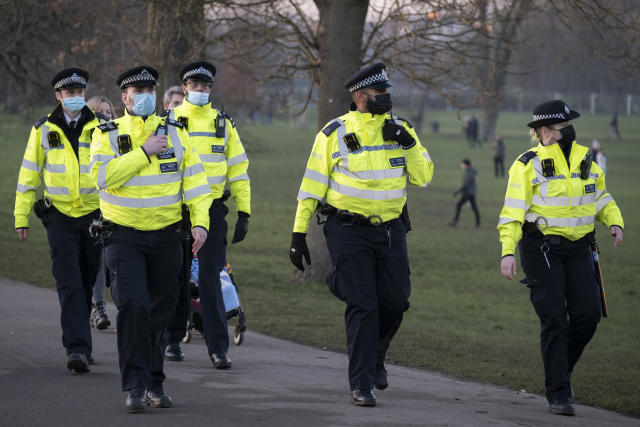 A day after London Mayor Sadiq Khan announced the spread of Covid is said to be out of control, Met police officers walk towards a group of Covid-deniers who are challenging lockdown rules and authoritarian control at passing south Londoners in Brockwell Park in Lambeth and during the third pandemic lockdown, on 9th January 2021, in London, England. The Coronavirus infection rate in London has exceeded 1,000 per 100,000 people, based on the latest figures from Public Health England although the Office for National Statistics recently estimated as many as one in 30 Londoners has coronavirus. (Photo by Richard Baker / In Pictures via Getty Images)