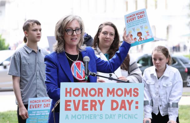 PHOTO: Kristin Rowe-Finkbeiner, MomsRising Executive Director/CEO joins members and their kids at a picnic on Capitol Hill to urge Congress to make child care affordable, pass paid leave, and support care infrastructure, May 17, 2023, in Washington. (Paul Morigi/Getty Images for MomsRising)