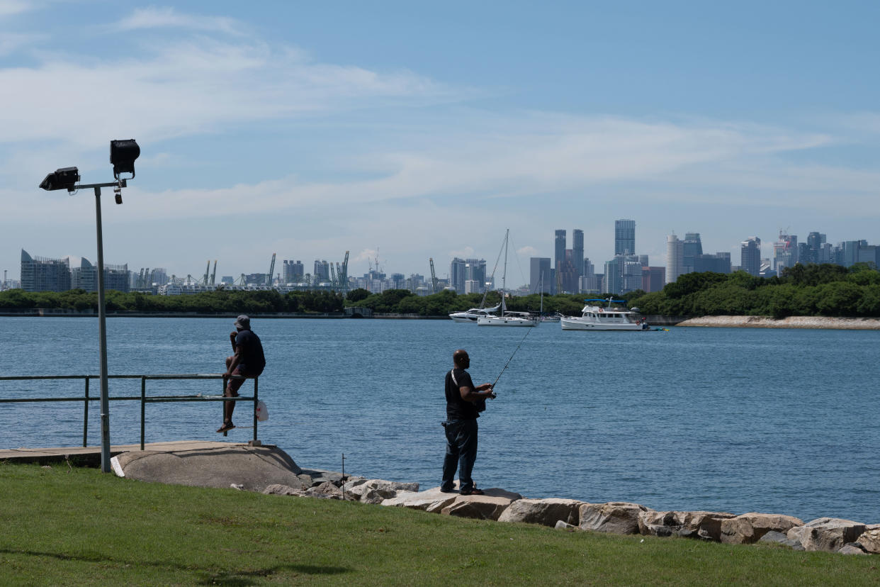 Fishermen fishing near St. John's Island Pier, an offshore island to the south of Singapore