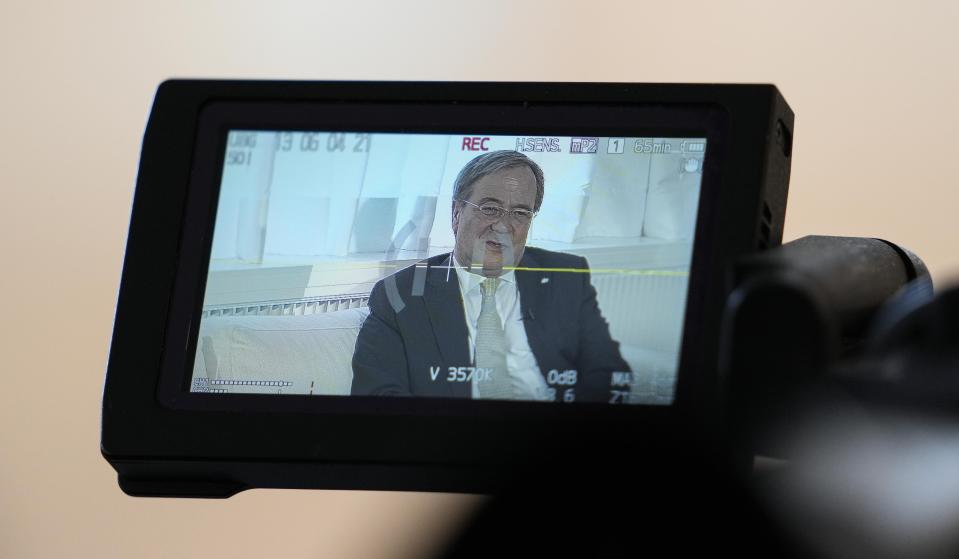 Governor of North Rhine-Westphalia Armin Laschet is pictured on a video camera screen during an interview with the Associated Press in his office in Duesseldorf, Germany, Wednesday, June 30, 2021. Laschet, the 60-year-old governor of Germany's most populous state, is the front-runner to succeed Angela Merkel as chancellor in the country's Sept. 26 election. (AP Photo/Martin Meissner)