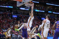 New Orleans Pelicans center Jaxson Hayes dunks against Phoenix Suns center Deandre Ayton (22) in the second half of Game 4 of an NBA basketball first-round playoff series in New Orleans, Sunday, April 24, 2022. (AP Photo/Matthew Hinton)