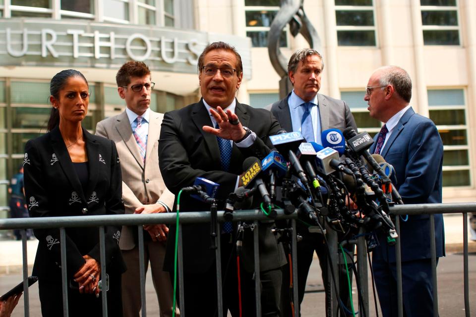 R. Kelly's legal team, including Douglas Anton, center, and Steve Greenberg, far right, after a hearing in Kelly's racketeering and sex trafficking case, outside federal court in Brooklyn on Aug. 2, 2019 in New York.