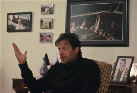 Imran Khan, Pakistani cricketer-turned-politician and chairman of the Pakistan Tehreek-e-Insaf (PTI) political party, speaks during an interview with Reuters at his office in Islamabad November 8, 2013. REUTERS/Mian Khursheed