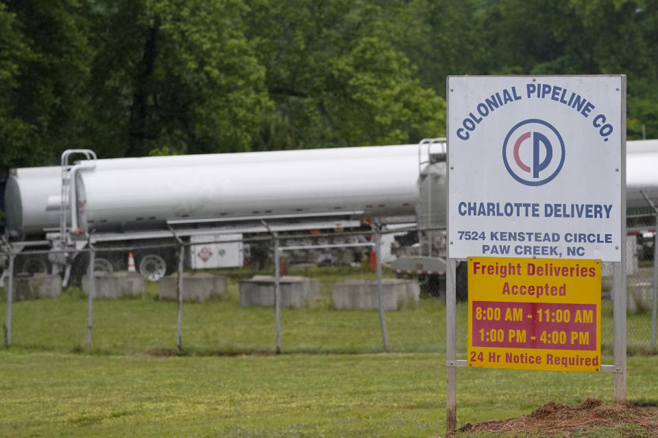 Tanker trucks are parked near the entrance of Colonial Pipeline Company Wednesday, May 12, 2021, in Charlotte, N.C.  Several gas stations in the Southeast reported running out of fuel, primarily because of what analysts say is unwarranted panic-buying among drivers, as the shutdown of a major pipeline by hackers entered its fifth day.  (AP Photo/Chris Carlson)