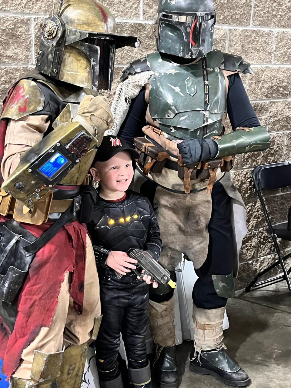 Colton Brown of Nappanee wasn't frightened by the Mandalorian Warriors from Star Wars who posed for photos Saturday at Comic Con in Elkhart.