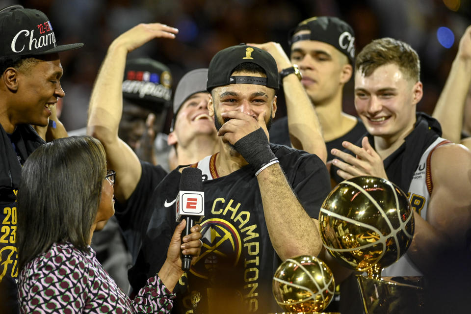 Denver Nuggets guard Jamal Murray celebrates on stage after the Nuggets won their first NBA championship on June 12, 2023 at Ball Arena in Denver. (AAron Ontiveroz/The Denver Post)
