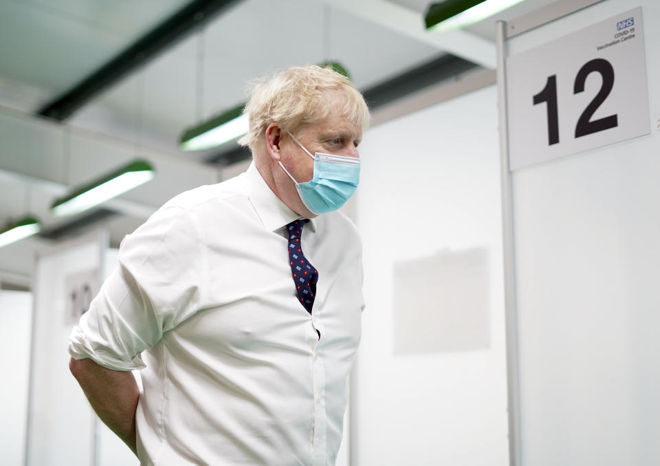 AYLESBURY, ENGLAND - JANUARY 03: Prime Minister Boris Johnson during a visit to a vaccination hub in the Guttman Centre at Stoke Mandeville Stadium as the booster vaccination programme continues, on January 3, 2022 in Aylesbury, Buckinghamshire. Around 132 million coronavirus jabs were given last year amid the largest vaccine campaign in British history. The emergence of the Omicron variant triggered an acceleration of the rollout over the festive season, and more than 1.6 million people received their booster dose in the final week of 2021.  (Photo by Steve Parsons - WPA Pool/Getty Images)